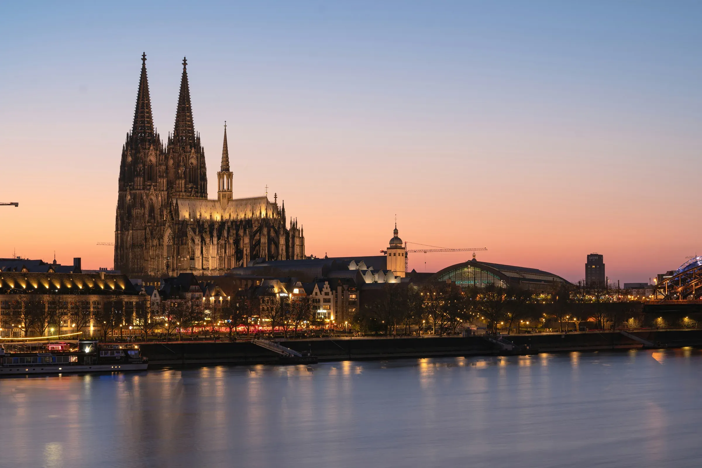 Cologne Cathedral and the Rhine riverfront at sunset